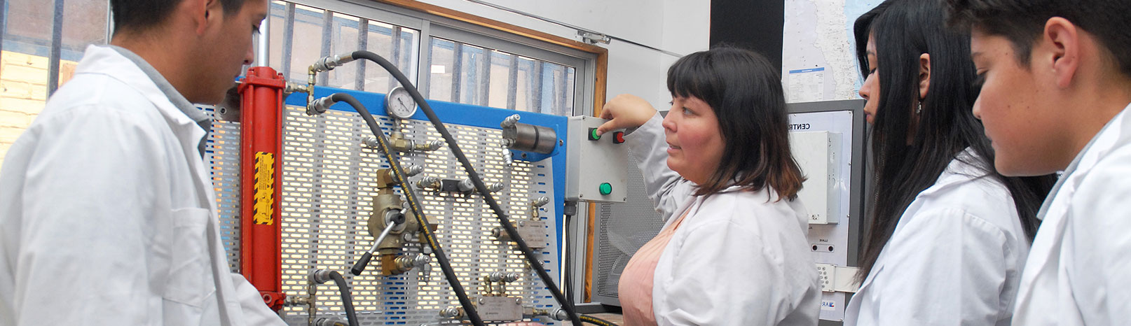 Fotografía de profesora y estudiantes de educación media técnico profesional