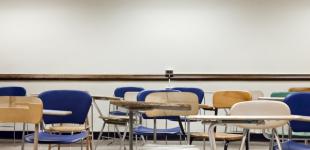 La imagen muestra una sala de clases vacía
