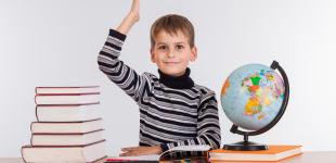 La imagen muestra a un niño con libros, lápices y globo terraqueo